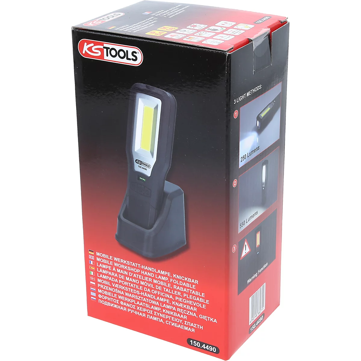 Een zwarte werkplaatslamp staat in zijn oplaadstation voor een rode doos. Op de doos staat "KS TOOLS".
